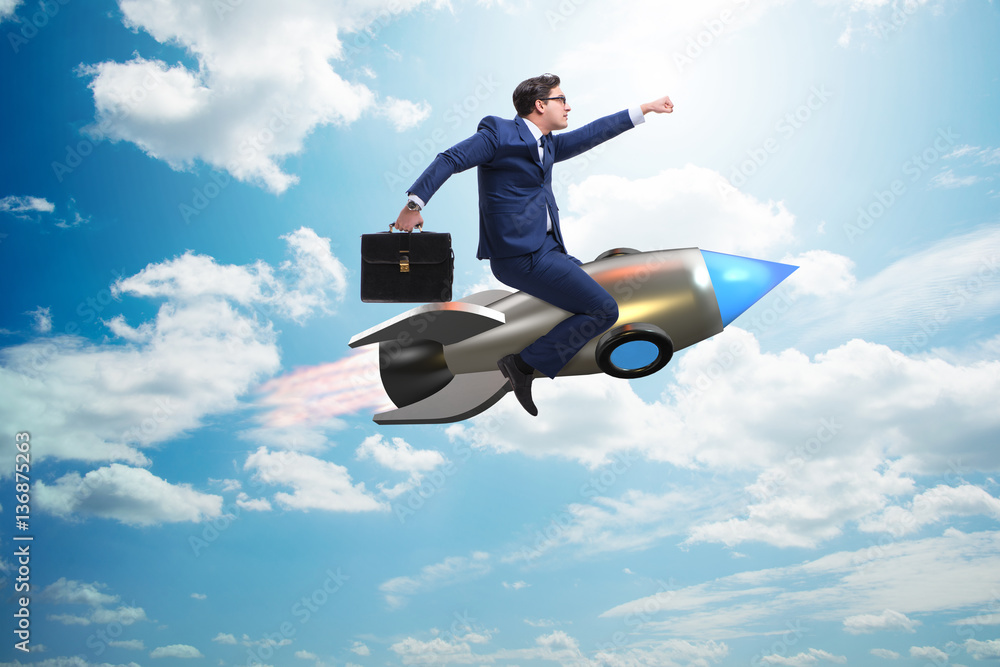 Businessman flying on rocket in business concept Businessman flying on rocket in business concept