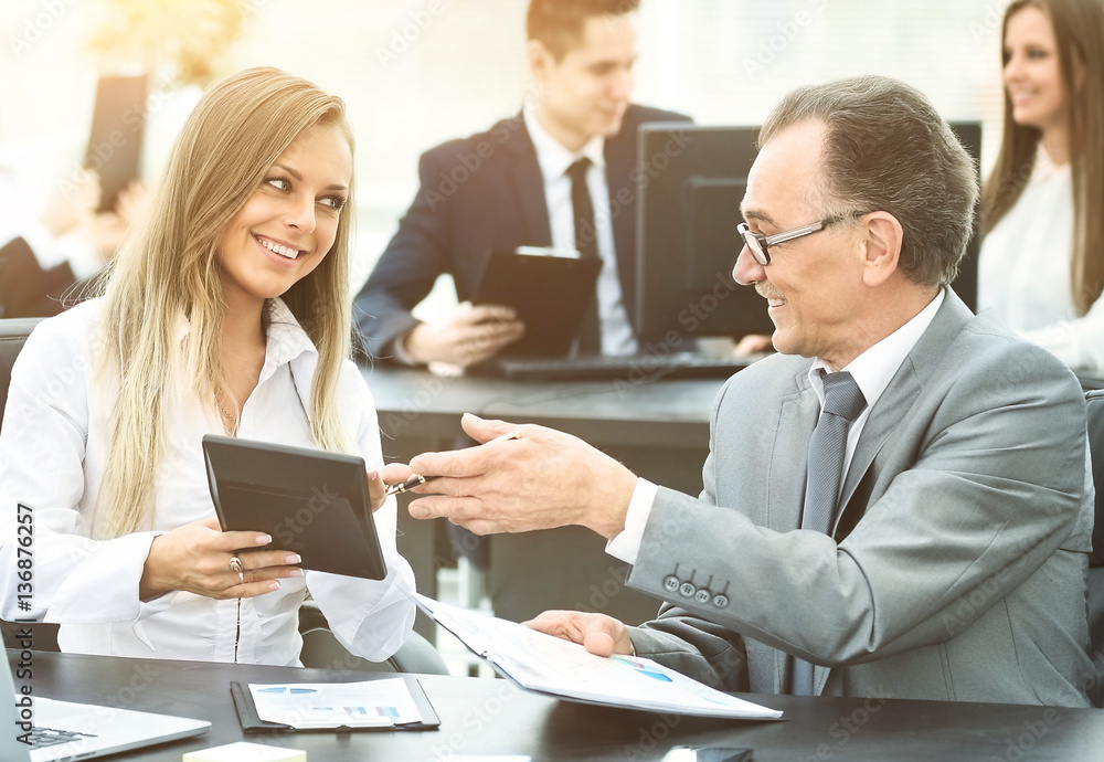 successful businessman and his assistant discuss the work successful businessman and his assistant discuss the work
