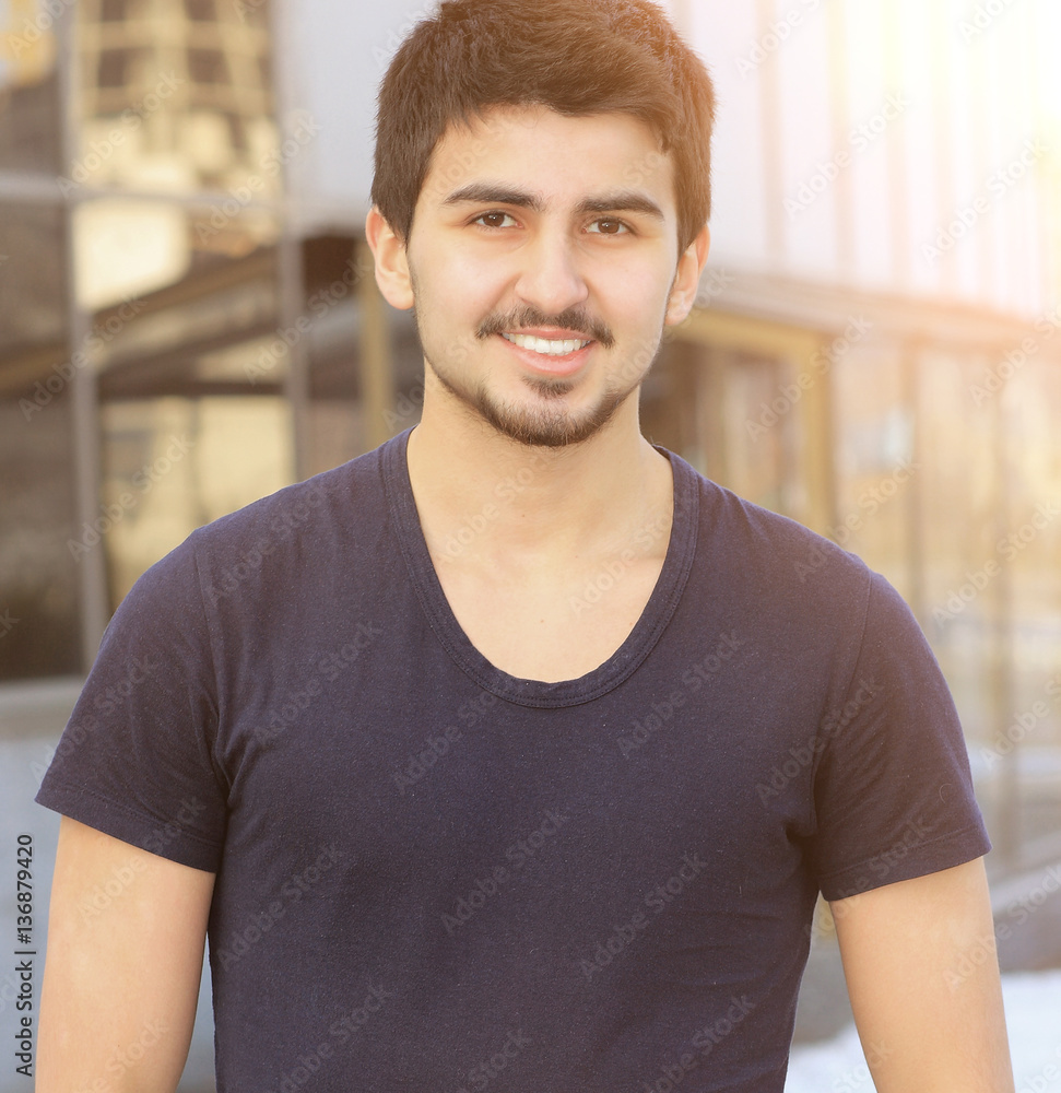 Happy Manager in a vest on a background of office building Happy Manager in a vest on a background of office building