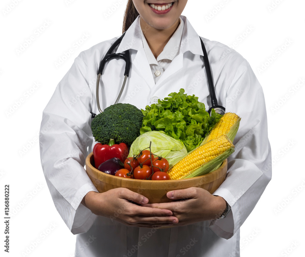 Cluseup of doctor hand holding the mix fresh vegetables in woode Cluseup of doctor hand holding the mix fresh vegetables in woode