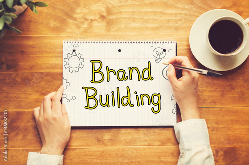 Brand Building text with a person holding a pen