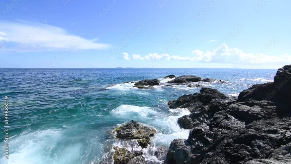 Gentle waves roll onto dark rocky shore at Punta Soldado in Isla Culebra, with native sound Gentle waves roll onto dark rocky shore at Punta Soldado in Isla Culebra, with native sound