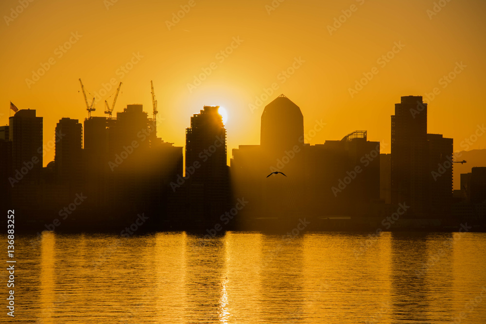 Sunrise, sunset on the background of the city. Orange sky.City silhouette. San Diego downtown