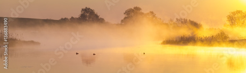 misty, fairytale sunrise over the lake