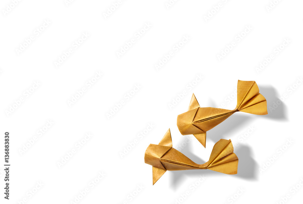 Obraz premium Handmade paper craft gold color origami koi carp fish on white background with empty space. 