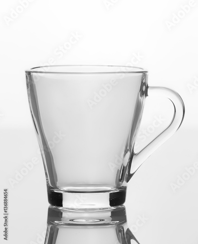 Empty glass cups of tea with handle isolated on white background