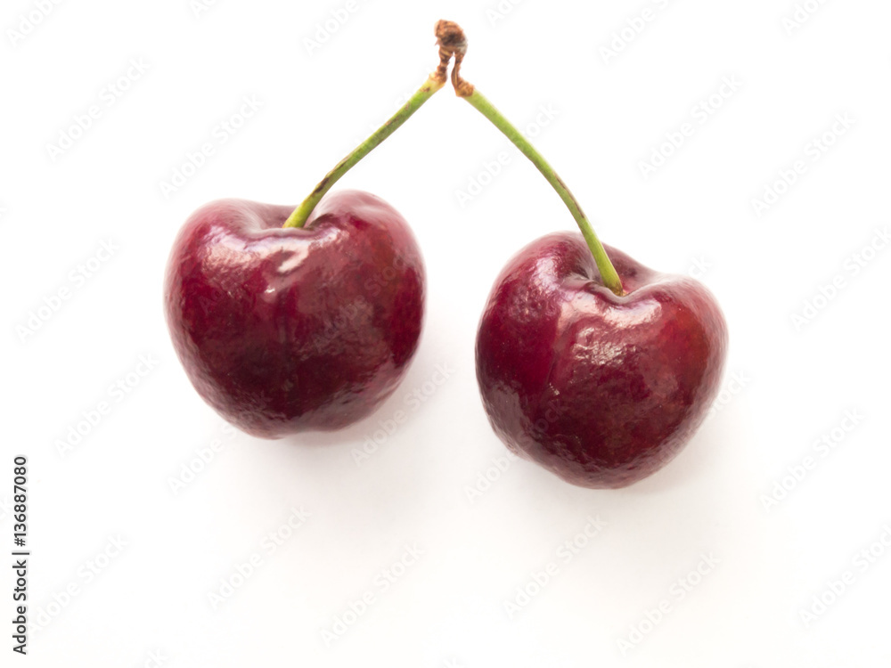 Two red cherry on white background