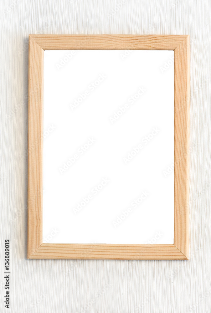 Light wooden frame for picture hanging on white wall Light wooden frame for picture hanging on white wall