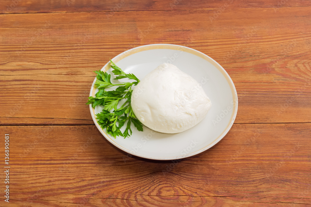 Mozzarella cheese with parsley on a saucer