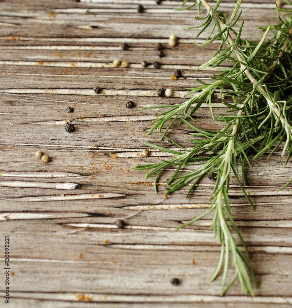 sprigs of rosemary with multi-colored pepper, selective focus sprigs of rosemary with multi-colored pepper, selective focus