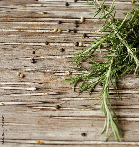 sprigs of rosemary with multi-colored pepper  selective focus