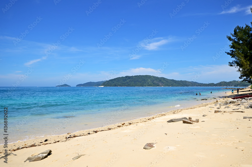 Beautiful beach scenery in Kota Kinabalu with blue sky and sea.