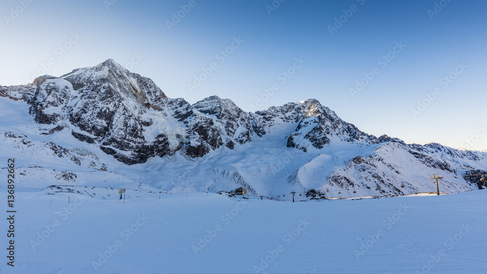 Ski winter season, ski run in Italian Alps. Solda with Ortler, Zebru, Grand Zebru in background. Val Venosta, South Tirol, Italy.