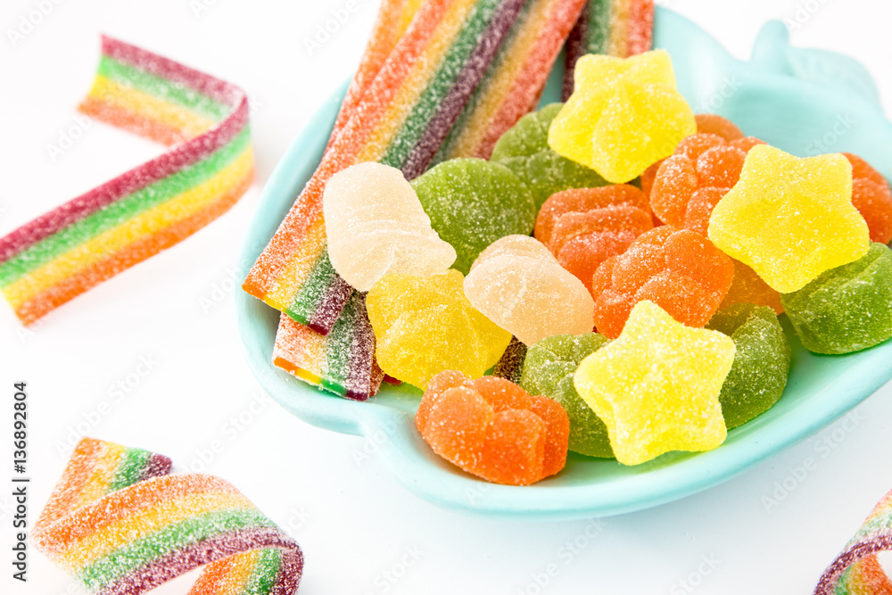 Candy background. Colorful candies in plate on light background