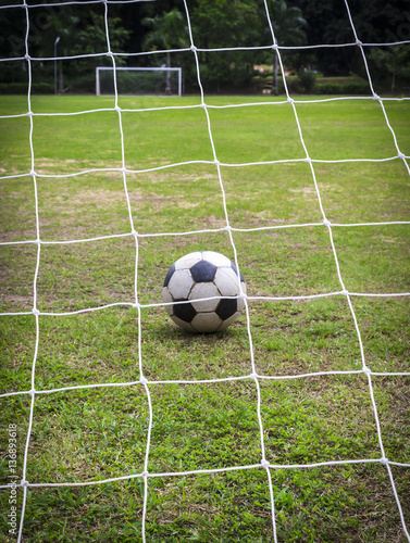 Old soccer ball on field © manus