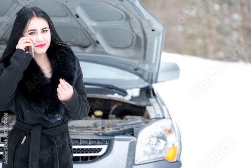 Young woman waiting for help or assistance after her car breakdo