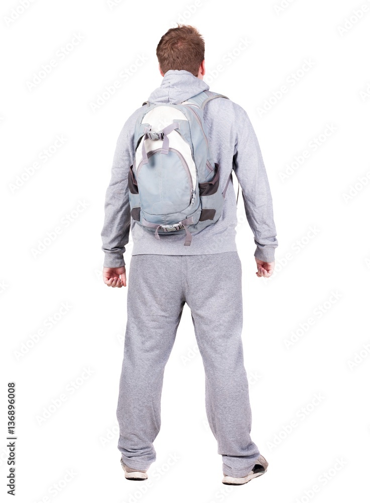 Back view of man with backpack looking up. Back view of man with backpack looking up.