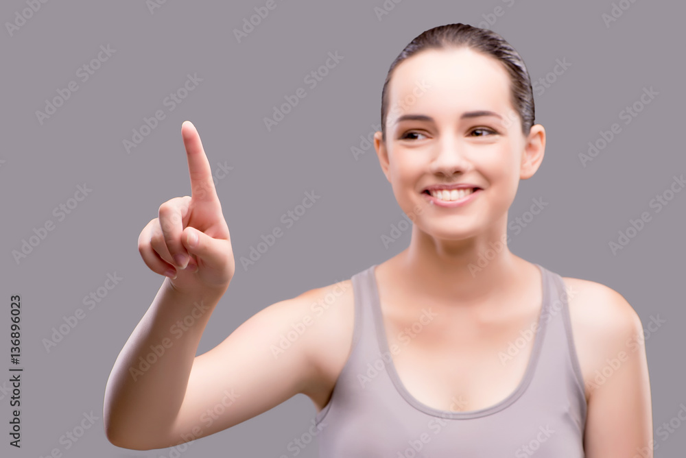 Young sports girl pressing virtual button Young sports girl pressing virtual button
