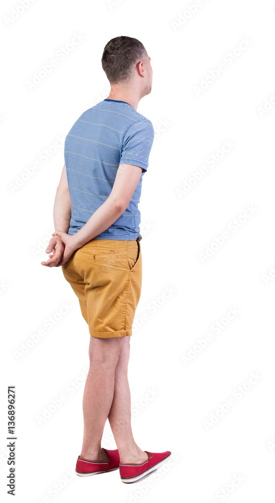 Back view of young manin shorts looking. Back view of young manin shorts looking.