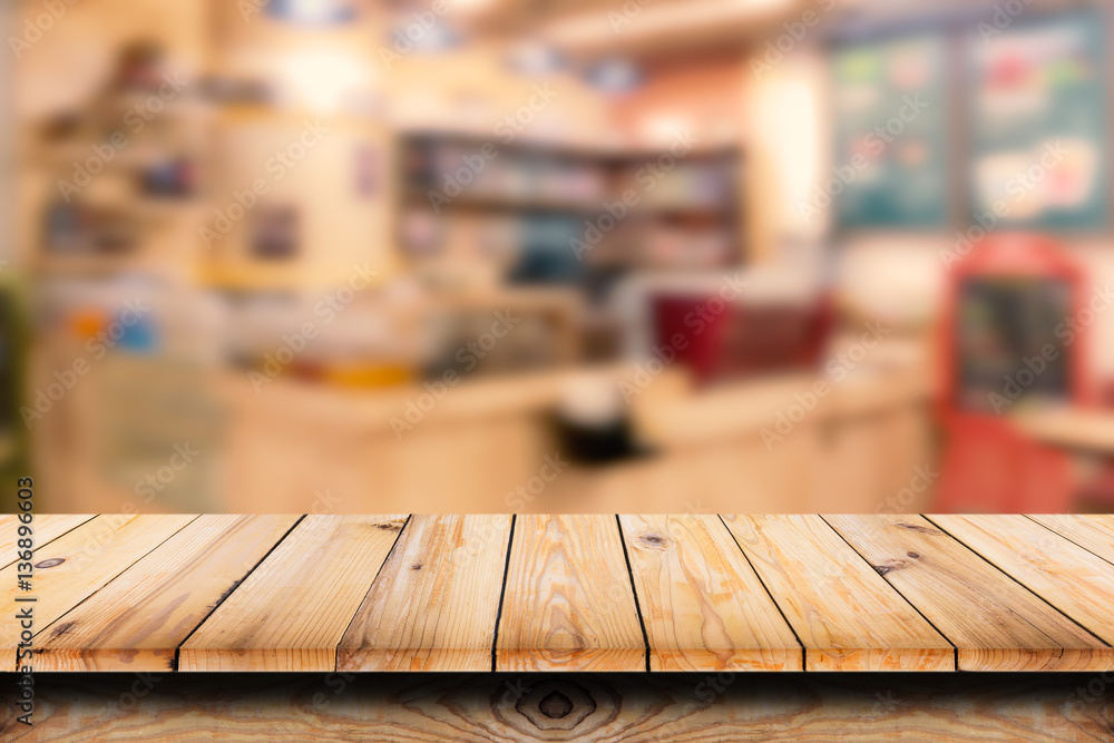 Empty top of wooden table with blur coffee shop background. Empty top of wooden table with blur coffee shop background.