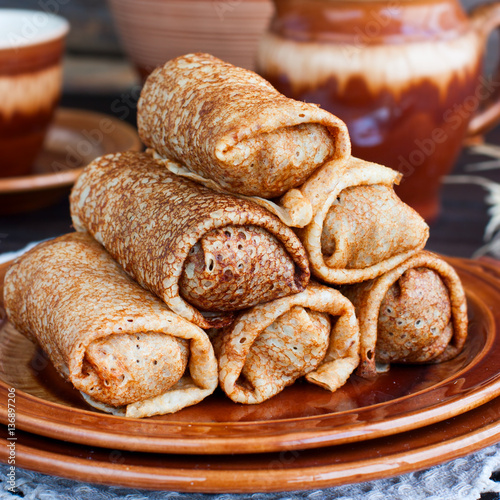 Stuffed pancakes on pottery, selective focus photo