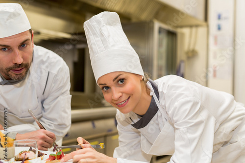 cooking class,culinary and food concept- Female cook cooking in kitchen