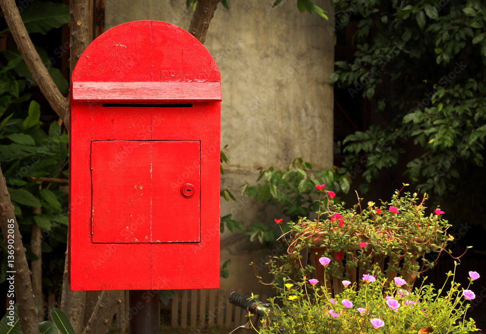 old red mailbox in the garden
