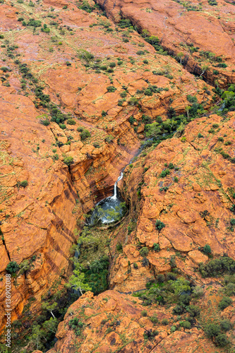 Kings Canyon Aerial View. View of famous Kings Canyon, Australia. Taken during a helicopter flight. Waterfall is visible in the center, there was heavy rain in the night.