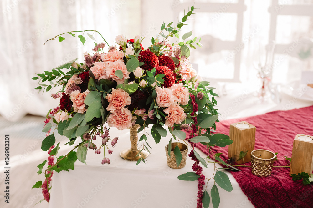 Wedding table decoration with the red and pink flowers on the white cloth Wedding table decoration with the red and pink flowers on the white cloth