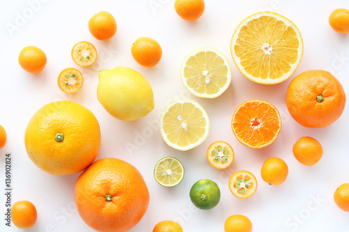 Various citrus fruits on white background