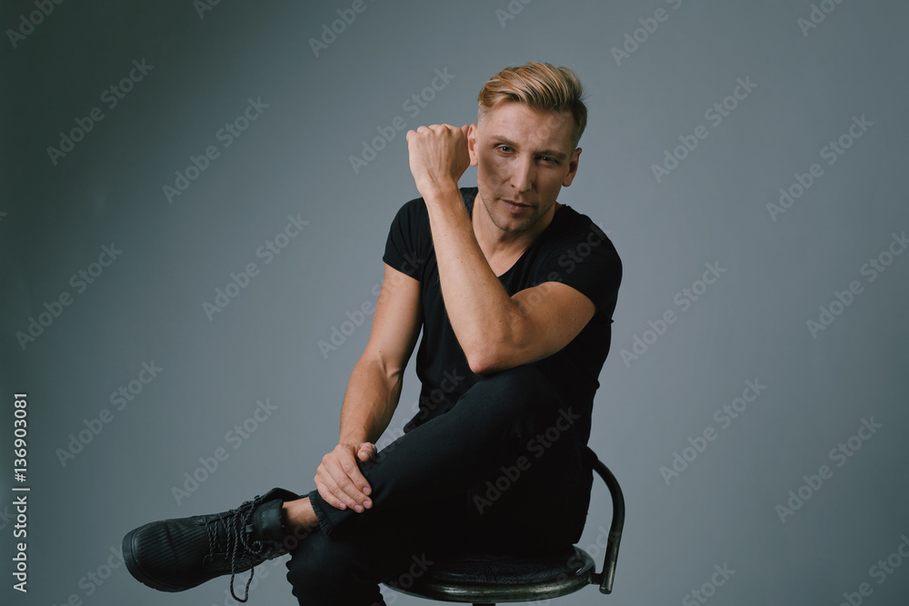Handsome blond young man posing at studio Handsome blond young man posing at studio