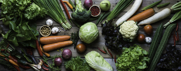 panorama of organic and raw vegetables on a wooden table