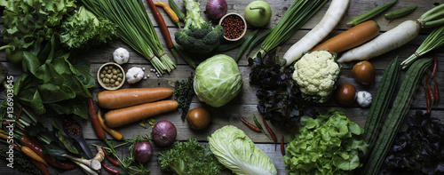 panorama of organic and raw vegetables on a wooden table