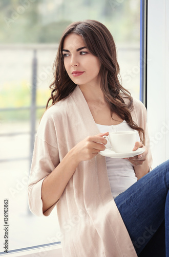 Beautiful woman with cup of...