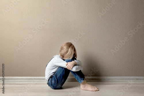Upset girl sitting on the f...