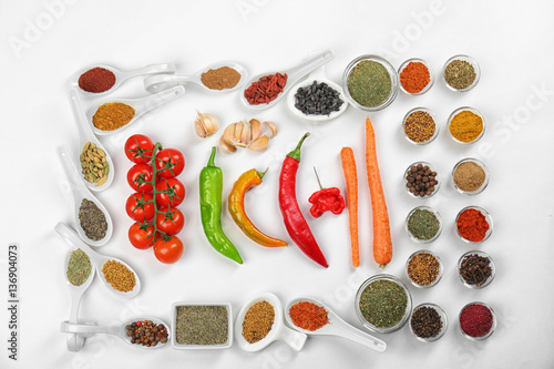 Different spices and fresh vegetables on white background