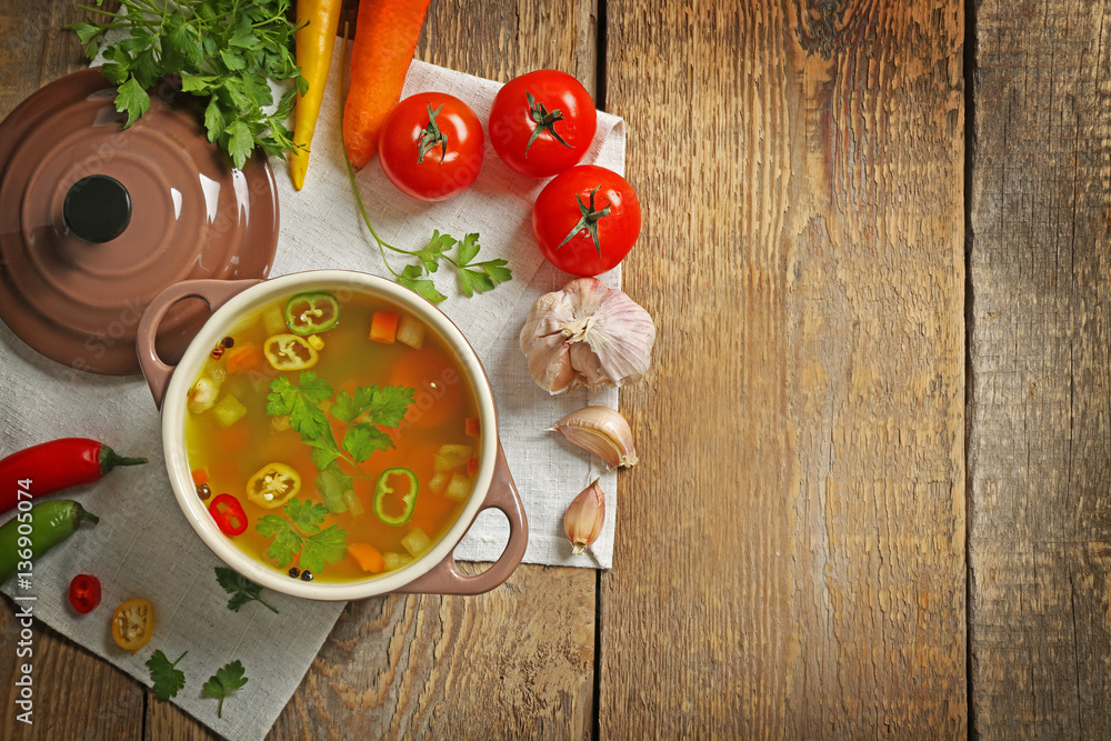 Soup and fresh vegetables on wooden background Soup and fresh vegetables on wooden background