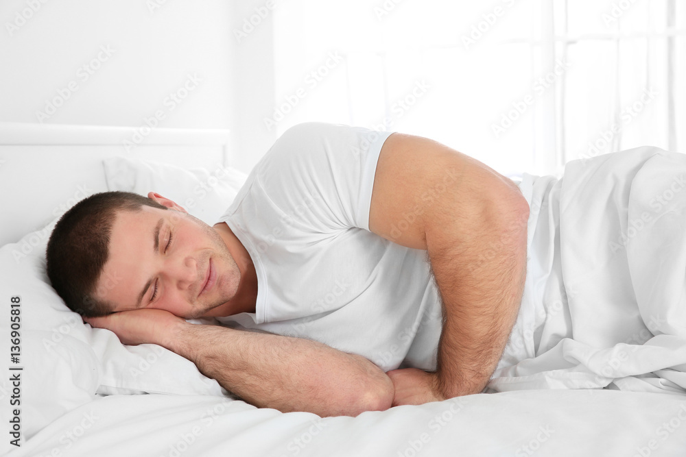 Young attractive man sleeping in bed at home Young attractive man sleeping in bed at home