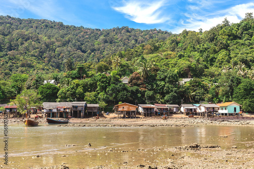 Fishing village at low tide - ethnic buildings, Thailand.