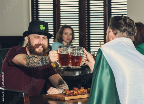 Men celebrating Saint Patrick s Day in pub