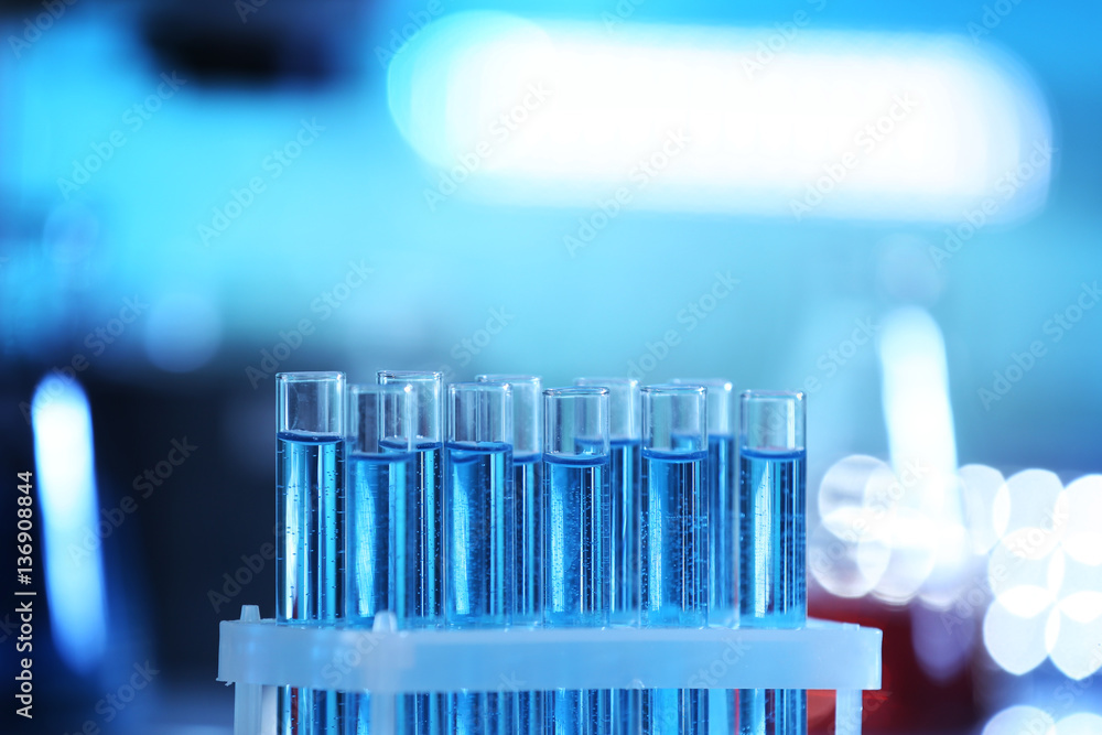 Test tubes in holder on blurred background Test tubes in holder on blurred background