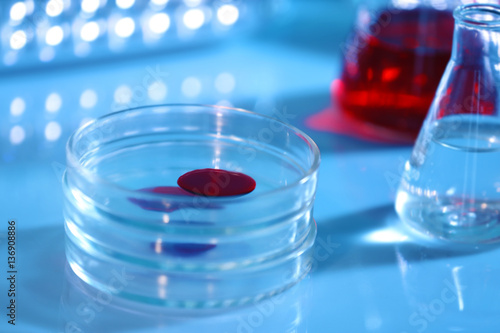 Chemical glassware with blood on blurred background