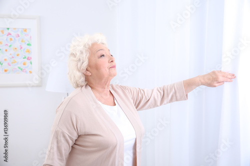 Elderly woman looking throu...