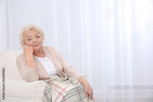 Elderly woman propping up f...