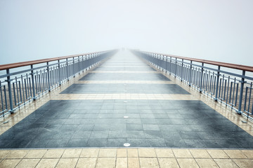 Bridge in а foggy morning /
A morning view of a bridge and silhouettes of people disappearing into the mist