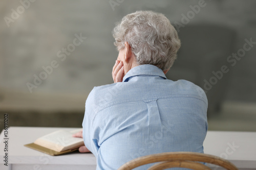 Depressed elderly woman at ...