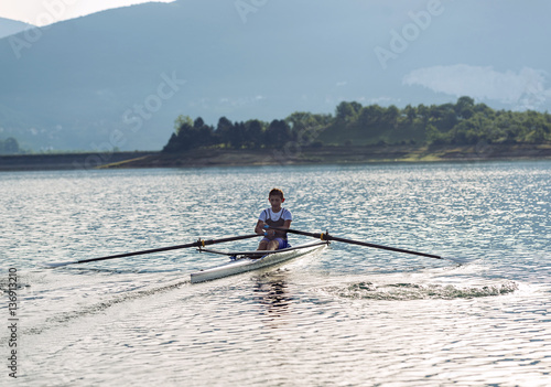 Child in the course of rowing on single