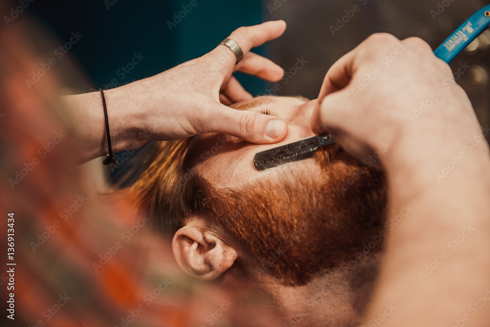 Fototapeta premium Professional Master hairdresser cuts client beard.