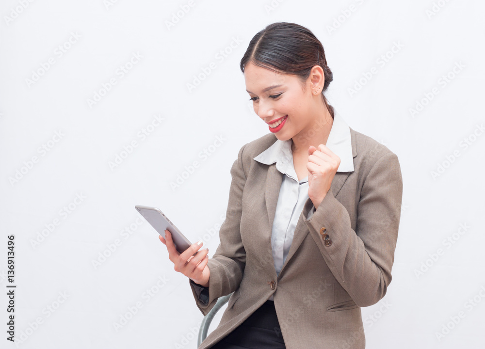 Businesswoman use of mobile phone. young woman used smart phone and tablet. business woman in the moment of success Businesswoman use of mobile phone. young woman used smart phone and tablet. business woman in the moment of success