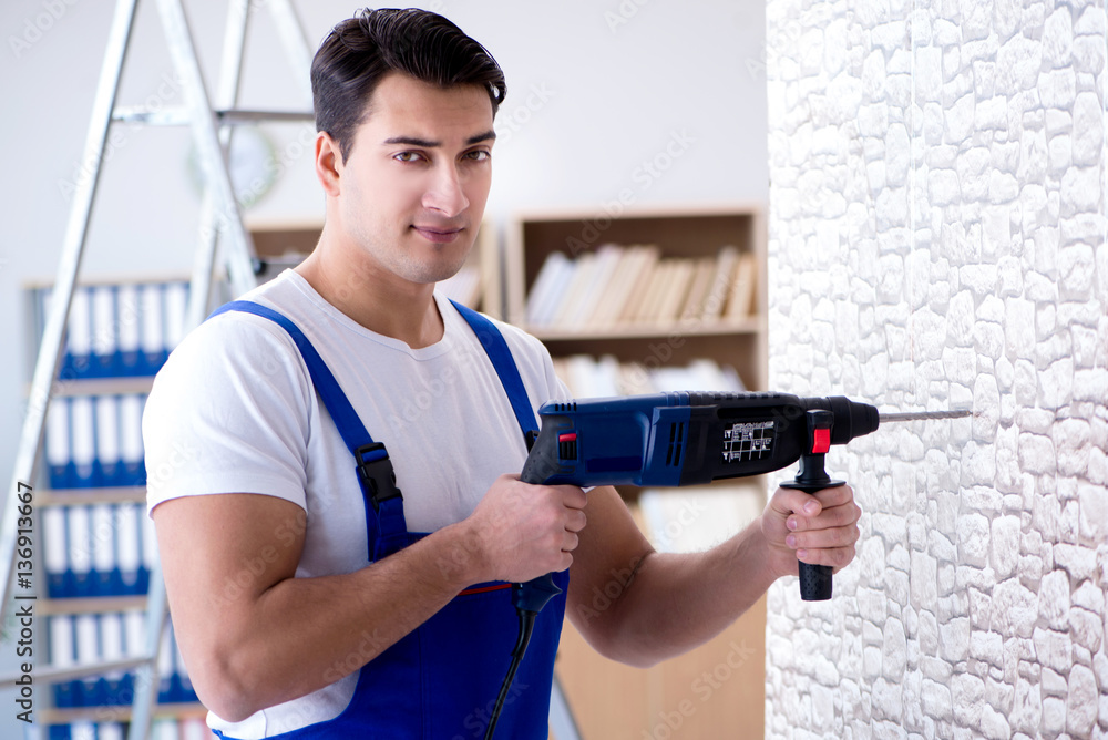 Repairman working with drilling drill perforator Repairman working with drilling drill perforator